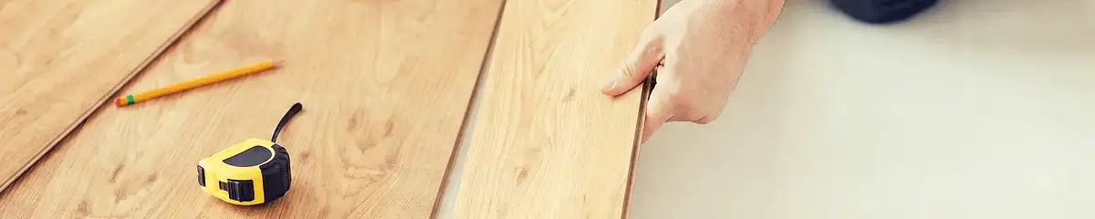 A professional installing wood flooring in Los Angeles, CA